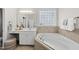 Lovely bathroom with a garden tub, vanity with a sink, and a window for natural light at 501 Ivyshaw Rd, Cary, NC 27519