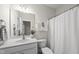 A bright bathroom features a large mirror, excellent lighting, and neutral finishes at 501 Ivyshaw Rd, Cary, NC 27519