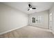 Neutral bedroom with a large window, neutral carpet, and a ceiling fan at 501 Ivyshaw Rd, Cary, NC 27519