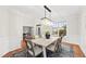 Bright dining room featuring stylish chandelier, window, and hardwood floors at 501 Ivyshaw Rd, Cary, NC 27519
