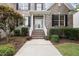 Inviting front entrance with brick stairs, white railings and a glass front door at 501 Ivyshaw Rd, Cary, NC 27519