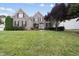 Beautiful two-story brick home with a large front yard and mature trees at 501 Ivyshaw Rd, Cary, NC 27519