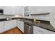Modern kitchen with stainless steel appliances, granite countertops, a tile backsplash and a stainless sink at 501 Ivyshaw Rd, Cary, NC 27519