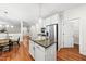 Open kitchen featuring granite countertops, a center island, stainless steel appliances and wood flooring at 501 Ivyshaw Rd, Cary, NC 27519