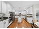 Bright kitchen featuring stainless steel appliances, a center island, and beautiful hardwood floors at 501 Ivyshaw Rd, Cary, NC 27519