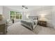 Cozy main bedroom with a large window, a ceiling fan and neutral decor at 501 Ivyshaw Rd, Cary, NC 27519