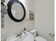 Charming powder room with a round mirror and stylish fixtures at 501 Ivyshaw Rd, Cary, NC 27519