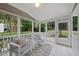Relaxing screened porch features two chairs, a small table, and lovely views of the backyard at 501 Ivyshaw Rd, Cary, NC 27519
