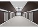 Large home theater with a projector, screen, and neutral carpeting at 501 Ivyshaw Rd, Cary, NC 27519