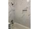 Bright bathroom with a bathtub, modern shower head, and stylishly tiled marble walls at 501 Morgan Ter, Burlington, NC 27217