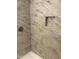 Custom tiled shower with built-in niche for toiletries, perfect for modern bathing needs at 501 Morgan Ter, Burlington, NC 27217