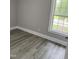 Bedroom with gray walls and laminate flooring features a large window, bringing in natural light at 501 Morgan Ter, Burlington, NC 27217