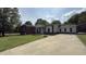 Ranch style home featuring a front driveway and yard with mature trees, offering curb appeal at 501 Morgan Ter, Burlington, NC 27217