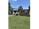 Charming brick home featuring a welcoming entrance and a well-manicured front yard with lush green grass at 501 Morgan Ter, Burlington, NC 27217
