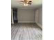 Bright living room featuring modern gray walls, trim and laminate flooring, creating a modern aesthetic at 501 Morgan Ter, Burlington, NC 27217