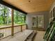 Spacious porch with natural wood elements, providing an inviting outdoor transition to wooded surrounding at 5027 Preacher Holmes Rd, Graham, NC 27253