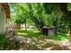 Overgrown backyard featuring a small shed, foliage, and debris throughout the yard at 503 Edwards Dr, Chapel Hill, NC 27516