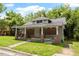 Exterior front view of a single-story home with a covered porch requiring major renovations at 503 Edwards Dr, Chapel Hill, NC 27516