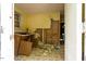 Damaged interior room with exposed walls, missing cabinets, and debris-strewn floor at 503 Edwards Dr, Chapel Hill, NC 27516