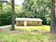 Cozy single-story brick house nestled among mature trees, offering a private, serene setting at 525 Locust Rd, Hillsborough, NC 27278