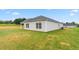 Large backyard with newly installed sod, side patio, and well-maintained lawn at 528 Lochalsh Dr, Gibsonville, NC 27249