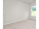 Bright bedroom featuring neutral carpeting and a window overlooking the outdoors at 528 Lochalsh Dr, Gibsonville, NC 27249