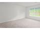 Bright bedroom featuring neutral carpeting and a window overlooking the outdoors at 528 Lochalsh Dr, Gibsonville, NC 27249