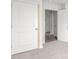 Bedroom with an open doorway, white doors, and neutral-colored carpet at 528 Lochalsh Dr, Gibsonville, NC 27249