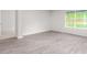 Spacious bedroom with a large window and attractive gray wood-look flooring at 528 Lochalsh Dr, Gibsonville, NC 27249