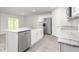 Modern kitchen features white cabinets, granite countertops, stainless steel appliances, and wood-look floors at 528 Lochalsh Dr, Gibsonville, NC 27249