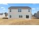 Exterior rear view of the home reveals a spacious yard at 597 Leven Dr, Gibsonville, NC 27249