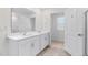 Elegant bathroom with double vanity, a walk-in shower, and access to an adjoining room at 597 Leven Dr, Gibsonville, NC 27249