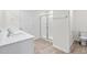 Stylish bathroom featuring dual sinks, a glass-enclosed shower, and modern fixtures at 597 Leven Dr, Gibsonville, NC 27249