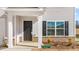 Close-up of the front porch featuring a black door and white pillars at 597 Leven Dr, Gibsonville, NC 27249