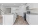 Modern kitchen features stainless steel appliances, white cabinets, and laminate flooring at 597 Leven Dr, Gibsonville, NC 27249