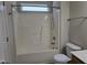 Bright bathroom featuring a shower-tub combo with white fixtures at 6408 Bunker Hill Dr, Raleigh, NC 27610