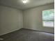 Bright bedroom with carpet, a window, and a closet at 6408 Bunker Hill Dr, Raleigh, NC 27610