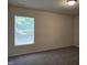 Bedroom with carpet, a window, and neutral-colored walls at 6408 Bunker Hill Dr, Raleigh, NC 27610