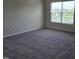 Bedroom featuring carpet, a window view of the trees, and neutral paint at 6408 Bunker Hill Dr, Raleigh, NC 27610