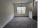 Bright dining room with carpet and a large window providing natural light at 6408 Bunker Hill Dr, Raleigh, NC 27610
