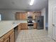 Well-lit kitchen featuring stainless steel appliances, ample countertop space, and wood cabinetry at 6408 Bunker Hill Dr, Raleigh, NC 27610