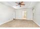 Spacious bedroom with neutral carpet, tray ceiling, and ceiling fan at 716 Beddingfield Dr, Knightdale, NC 27545