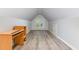 Finished attic bedroom with wood-look floors, desk, dormer window, and unique ceiling at 716 Beddingfield Dr, Knightdale, NC 27545