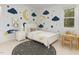 Bright bedroom with a large bed, nightstand, a constellation rug, and moon and star themed wall art at 716 Beddingfield Dr, Knightdale, NC 27545