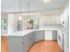 Modern kitchen with white cabinets, gray countertops, and a view of the backyard at 716 Beddingfield Dr, Knightdale, NC 27545