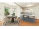 Modern kitchen with white cabinets, breakfast bar, and adjacent dining area at 716 Beddingfield Dr, Knightdale, NC 27545