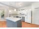 Bright kitchen featuring white cabinets, an island with seating, and modern appliances at 716 Beddingfield Dr, Knightdale, NC 27545