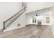 Open-concept living area with hardwood floors, a fireplace, and large windows at 716 Beddingfield Dr, Knightdale, NC 27545