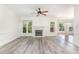Bright and open living space showcasing hardwood floors, a fireplace, and ample natural light at 716 Beddingfield Dr, Knightdale, NC 27545