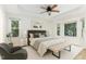 The main bedroom featuring a ceiling fan, multiple windows, and neutral decor at 716 Beddingfield Dr, Knightdale, NC 27545